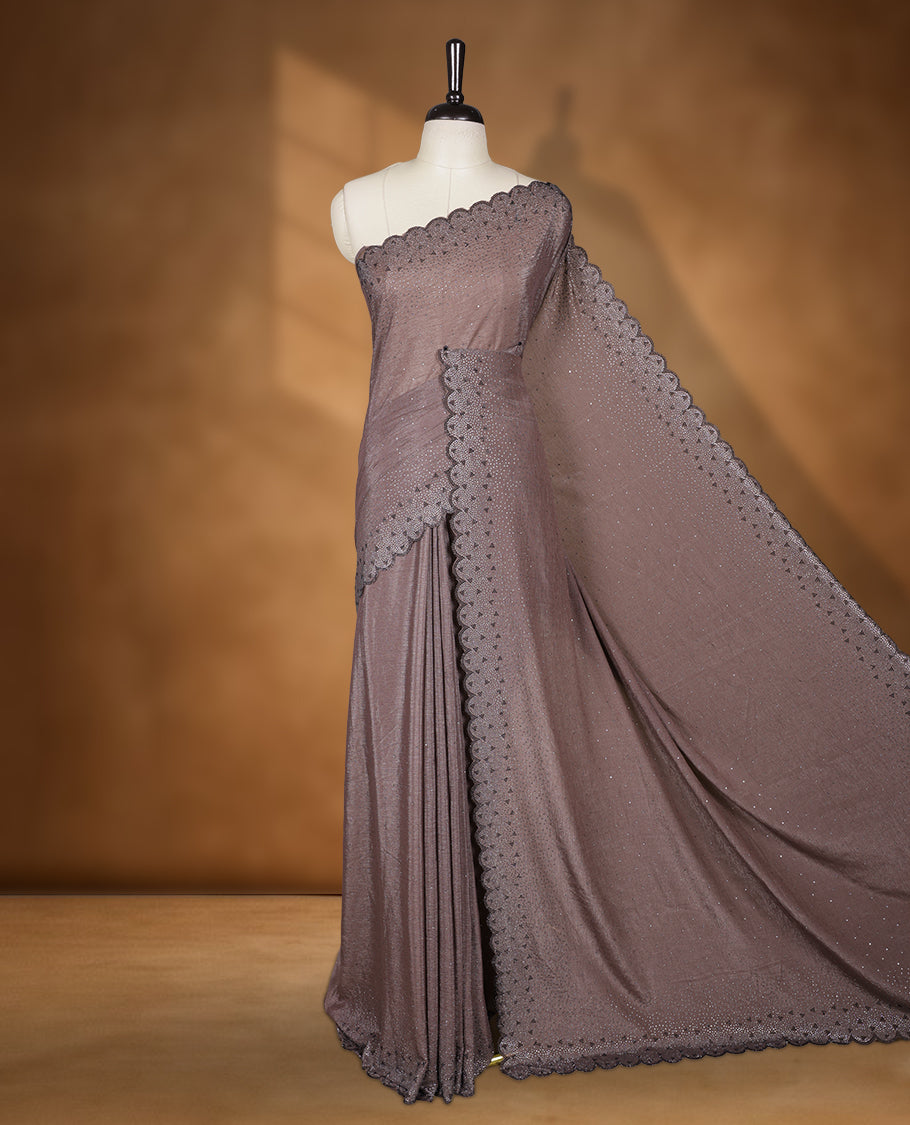 Dusty brown colour chiffon designer saree, featuring black and white scattered stone on body, stone work and heavy stone pattern on border and  pallu, Paired with matching blouse.