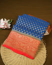 Dark Blue colour pure Banarasi Georgette saree featuring Antique zari Flower Motifs all over the body, complemented by an contrast Red dye colour with gold zari Floral Kodi Worked border and pallu, with matching blouse.