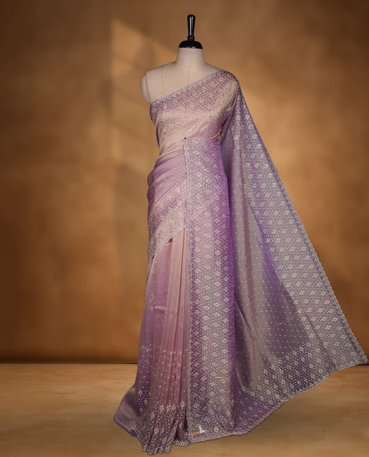 Lavender Colour Shimmer Designer Saree featuring Delicate White Stone Scattered Work on the Body, enhanced with Intricate Stone Detailing on the Border and Pallu, paired with a Matching Blouse.