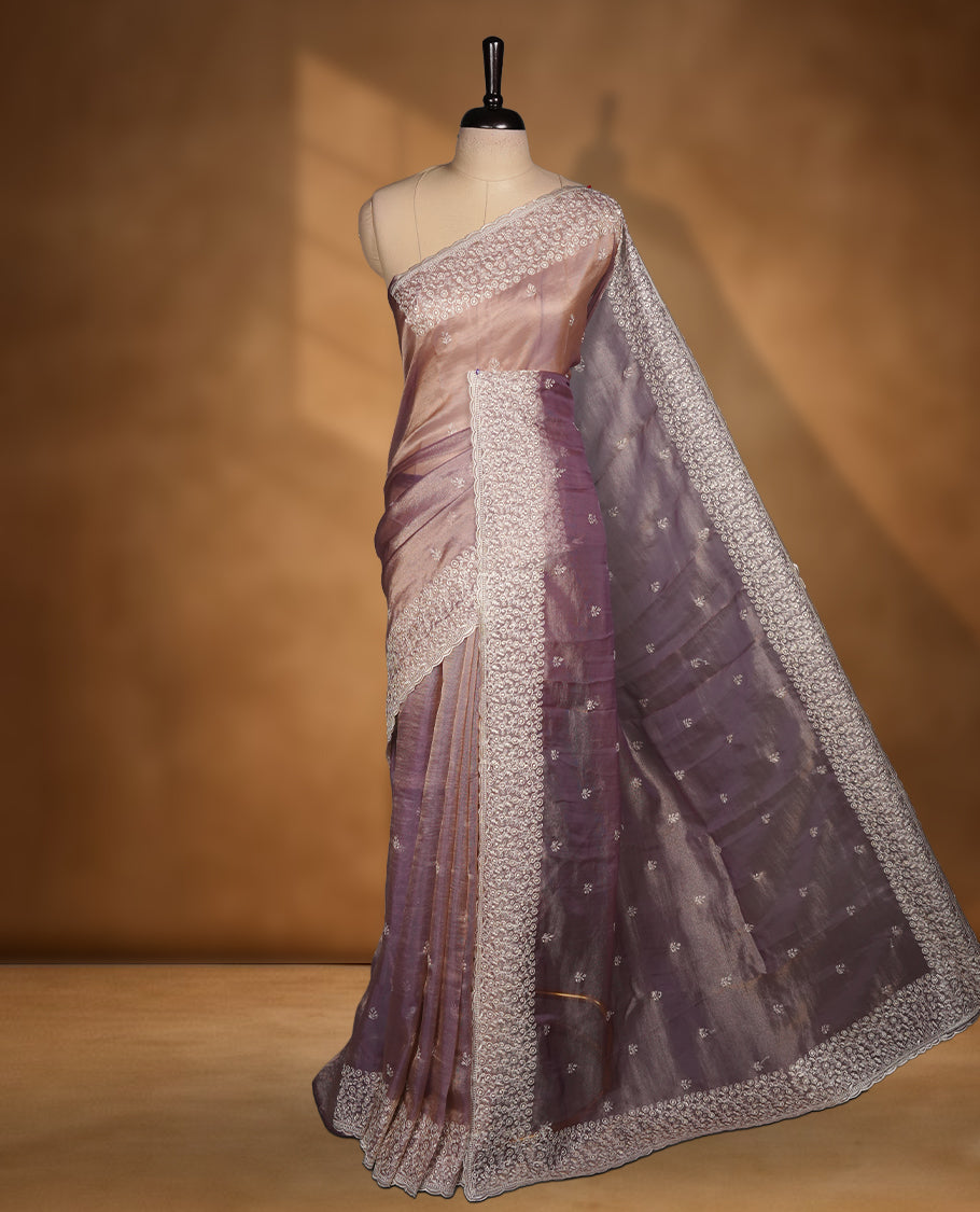 Pastel Purple colour net organza saree featuring white thread embroidery motifs on body and  thread detailing on the border and paired matching blouse.
