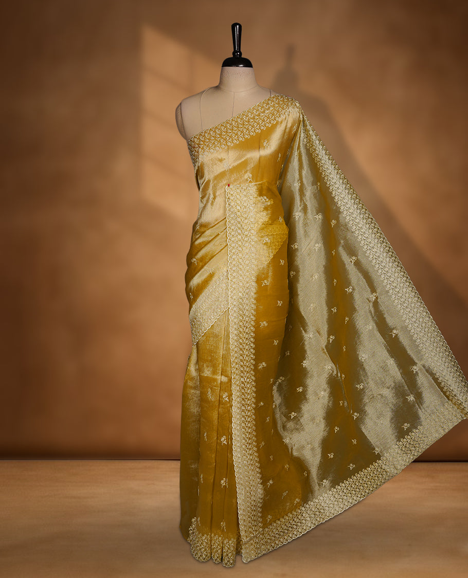 Pastel yellow colour organza saree featuring white thread embroidery motifs on body and  thread detailing on the border and paired matching blouse.