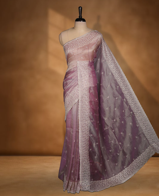Pastel Lavender colour net organza saree featuring white thread embroidery motifs on body and  thread detailing on the border and paired matching blouse.