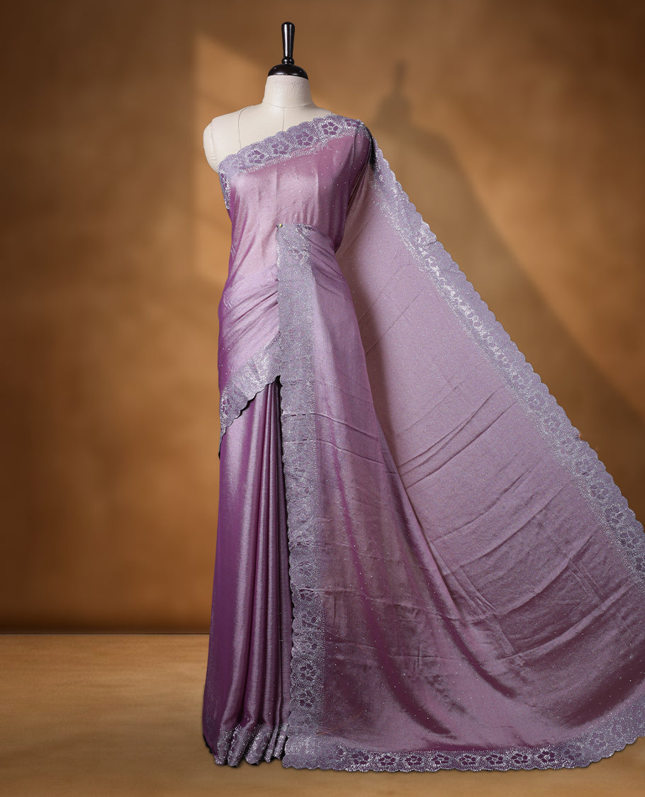 Lavender colour shimmer designer saree, featuring white scattered stone on body, stone work and heavy stone floral pattern on border and  pallu, Paired with matching blouse.