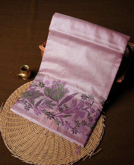 Pastel pink colour Pure tusser silk saree featuring finely crafted floral thread embroidery detailing on the border, pallu and with matching blouse piece.