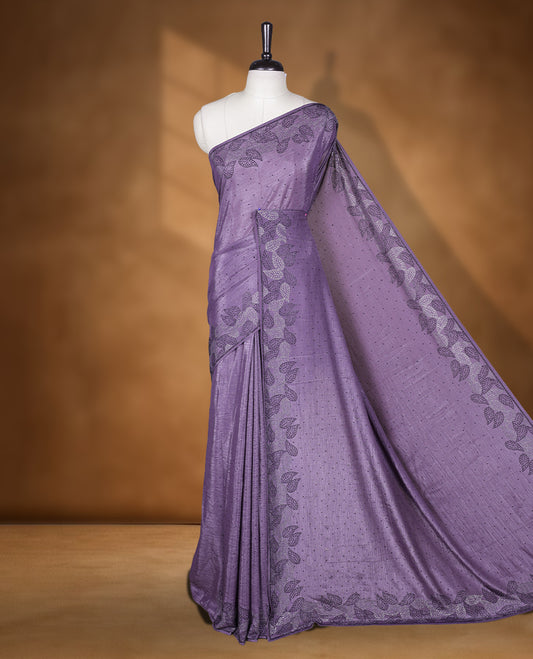 Dusty purple colour chiffon designer saree, featuring black and white scattered stone on body, stone work and heavy stone leaf pattern on border and  pallu, Paired with matching blouse.