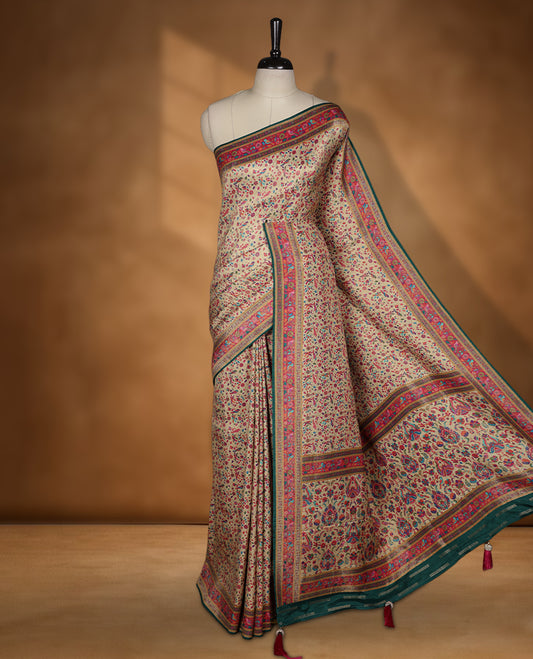 Beige colour Pashmina silk saree intricately woven with all over multicolour floral and paisley vines, accented by a rich pink and green zari border with bird motifs and a coordinated grand pallu, paired with a contrasting matching blouse piece.
