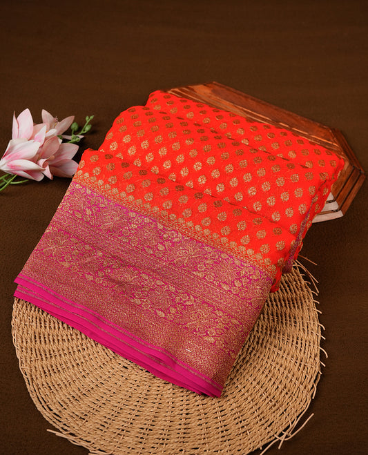 Orange colour pure Banarasi Crepe saree featuring Antique zari Flower Motifs all over the body, complemented by an contrast Pink dye colour with gold zari Floral Kodi Worked border and pallu, with matching blouse.