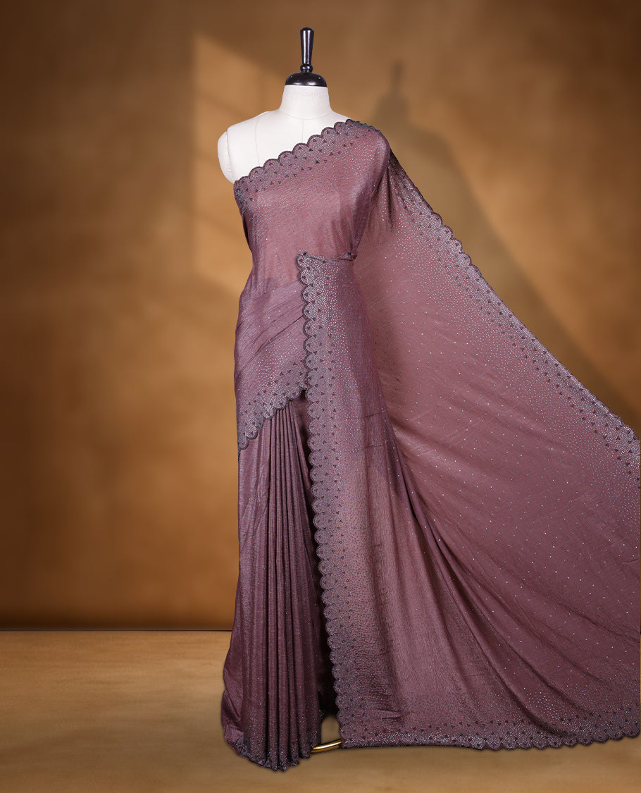 Brown colour chiffon designer saree, featuring black and white scattered stone on body, stone work and heavy stone leaf pattern on border and  pallu, Paired with matching blouse.