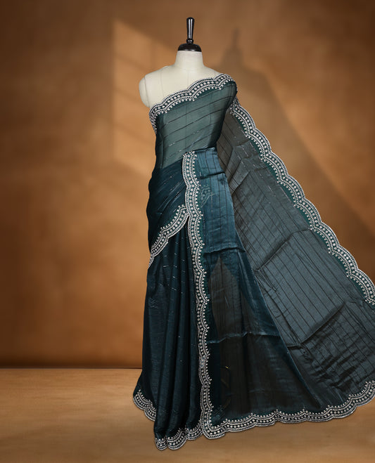 Dark green colour chiffon designer saree, featuring self colour beats stripes on body, heavy gold stone patttern on border and  pallu, Paired with matching blouse.