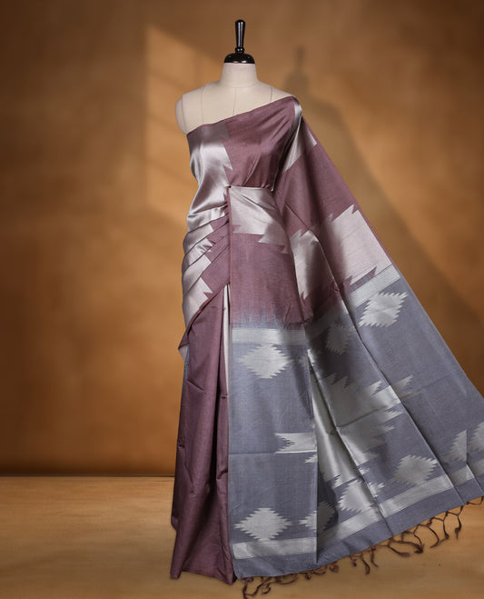 Brown and brown silver dual tone semi tussar saree featuring woven abstract geometric motifs on the body, complemented by a ikat inspired patterned pallu, paired with a matching blouse.