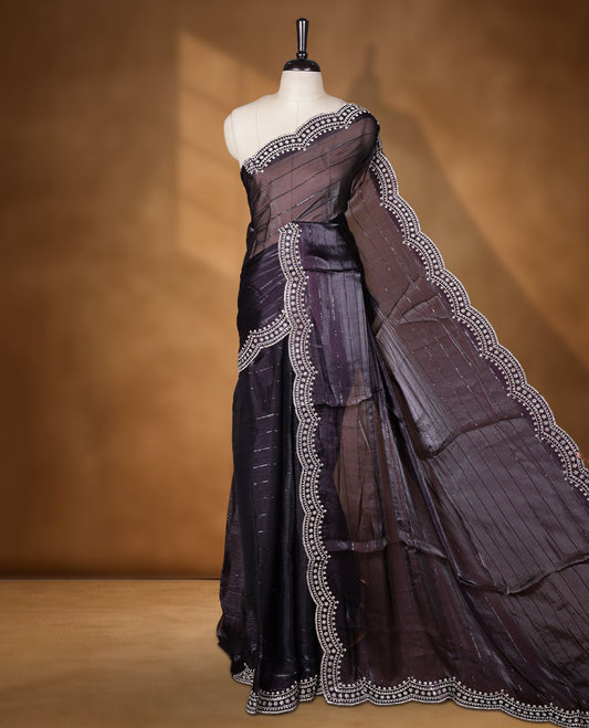 Dark Grape colour chiffon designer saree, featuring self colour beats stripes on body, heavy gold stone patttern on border and  pallu, Paired with matching blouse.