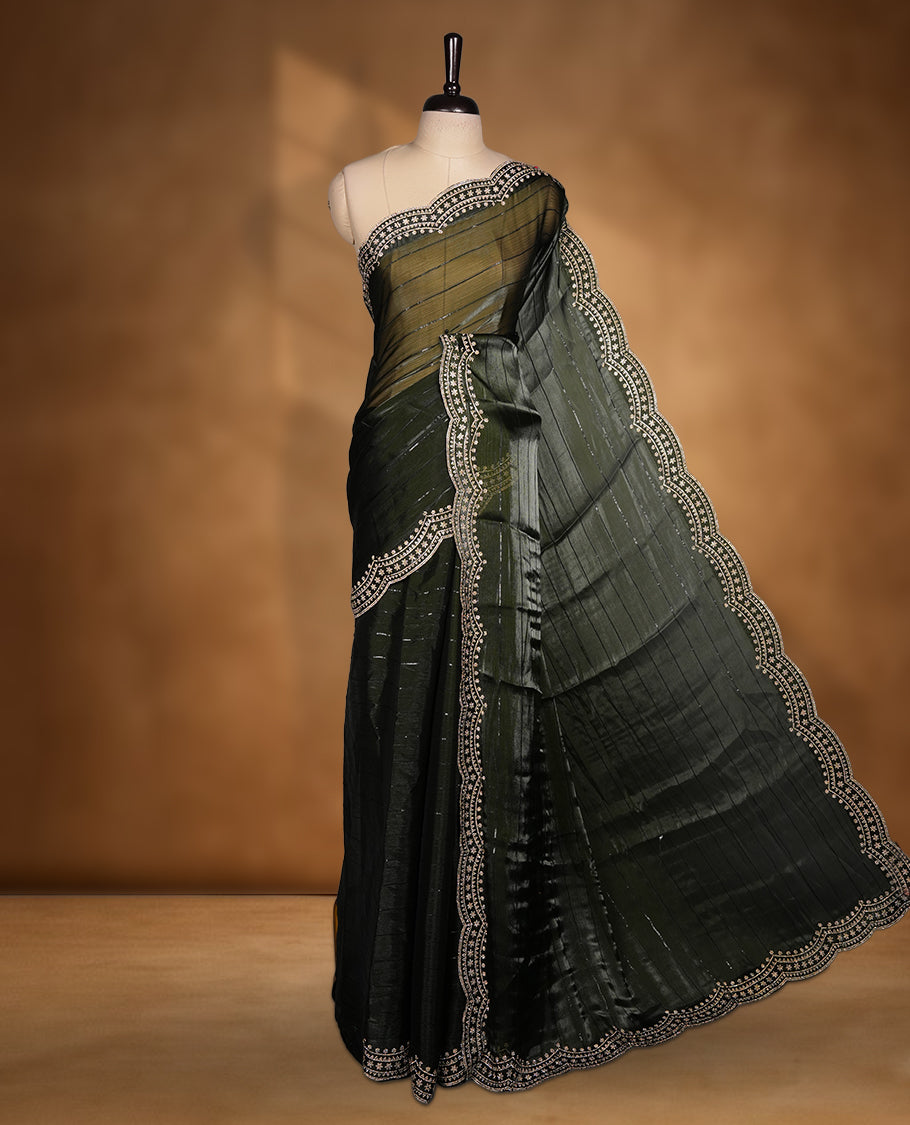 Dark olive green colour chiffon designer saree, featuring self colour beats stripes on body, heavy gold stone patttern on border and  pallu, Paired with matching blouse.