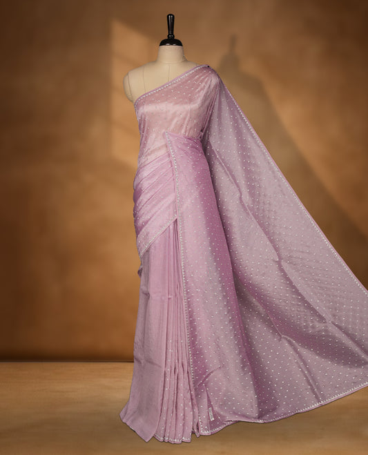 Light Purple Colour net shimmer fancy saree adorned with white stone buttas all over the body, paired with a delicate stone worked border and matching blouse