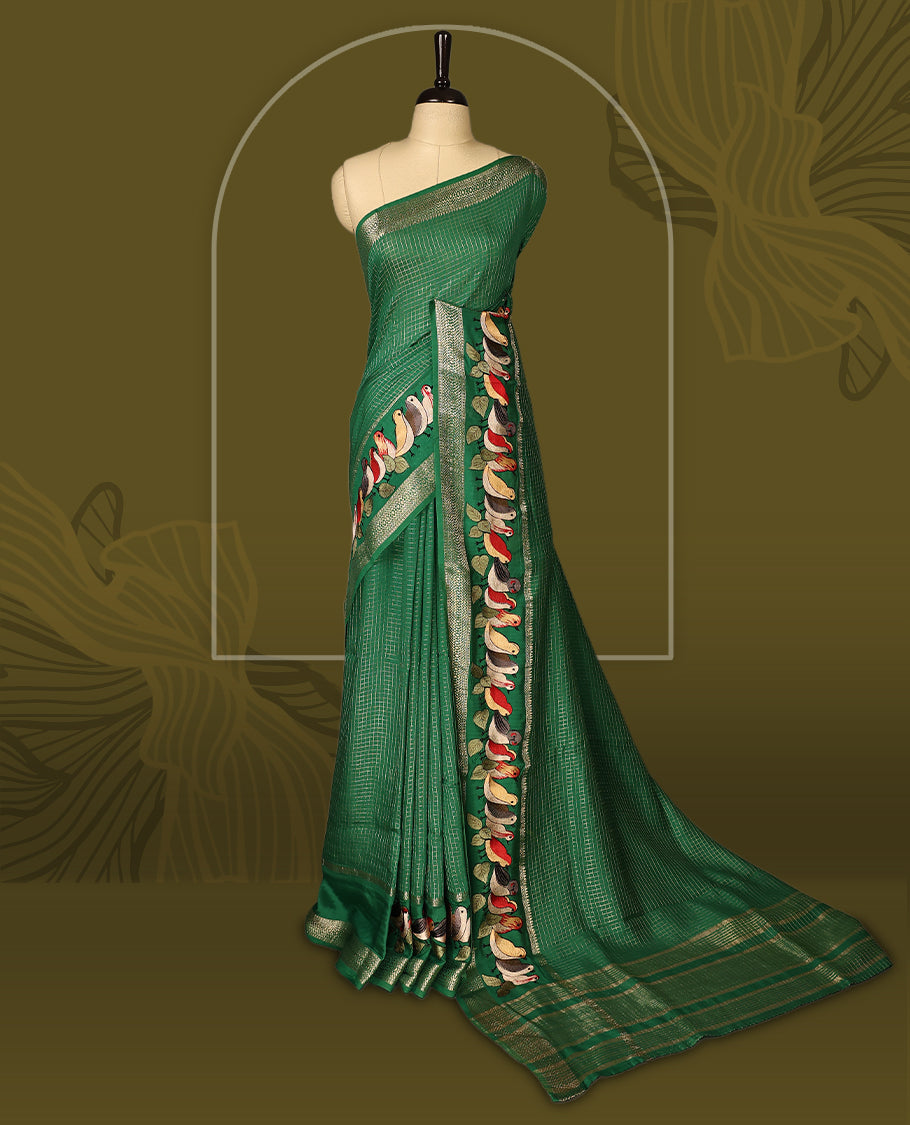 Green viscose saree featuring subtle checkered patterns and a beautifully embroidered bird motif border, paired with a rich pallu & perfect for festive occasions, celebrations, and elegant gatherings.