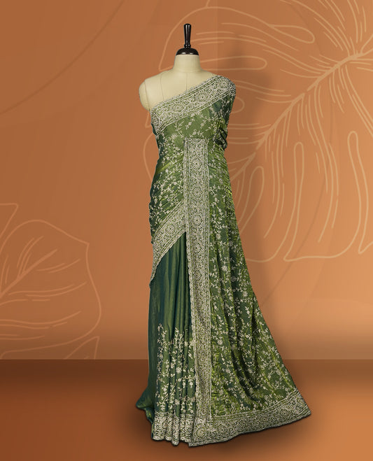 Pista green colour velvet chiffon designer saree in elegant two tone shades, featuring light gold zari, kodi work with handwoven style thread aari & dori embroidery work, Swarovski stone work and all over motifs, comes with matching blouse.