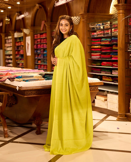 Lemon Yellow colour viscose saree in rich teal shade featuring a subtle sheen and lightweight drape, enhanced with satin piping finished border, paired with a matching blouse piece