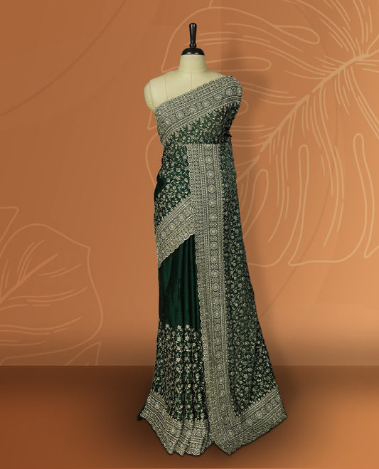 Royal Green colour velvet chiffon designer saree in elegant two tone shades, featuring light gold zari, kodi work with handwoven style thread aari & dori embroidery work, Swarovski stone work and all over motifs, comes with matching blouse.