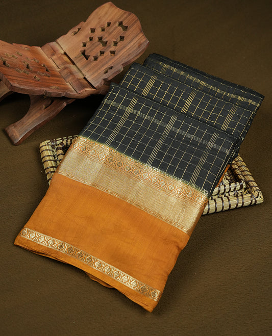 black colour mixed chanderi cotton saree with golden checkered body, mustard orange pallu with golden zari border, matching blouse.