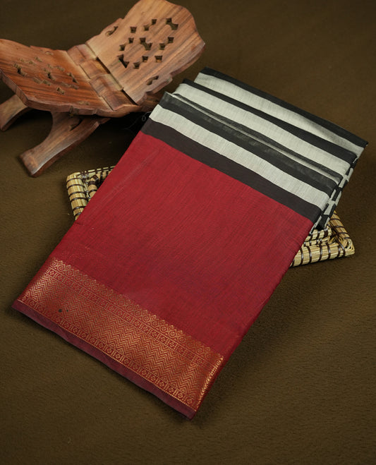 Maroon red colour mixed chanderi cotton saree with plain body, geometric tribal printed pallu with golden zari border, and striped blouse.