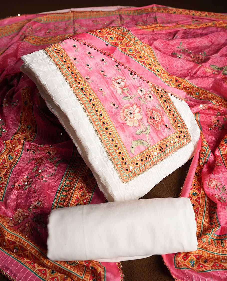 White colour churidhar material featuring Mirror and thread embroidery, foral print pattern on the contrast Pink colour front panel, floral digital printed dupatta with elegant border, and matching plain bottom