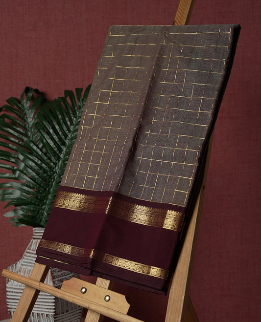 Grey colour Pure Kanchi cotton saree adorned with golden checks, complemented by a rich maroon zari border, paired with a matching blouse & A timeless blend of tradition and elegance, perfect for festive and casual wear.