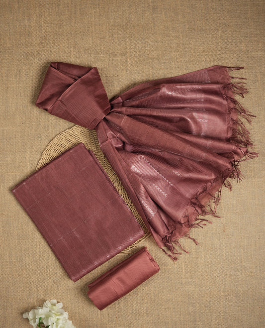 Pastel chocolate brown colour tussar suit material featuring a subtle self copper zari woven vertical and stripped pattern on the body, paired with a lightweight matching dupatta with tassel edges and a plain bottom piece.