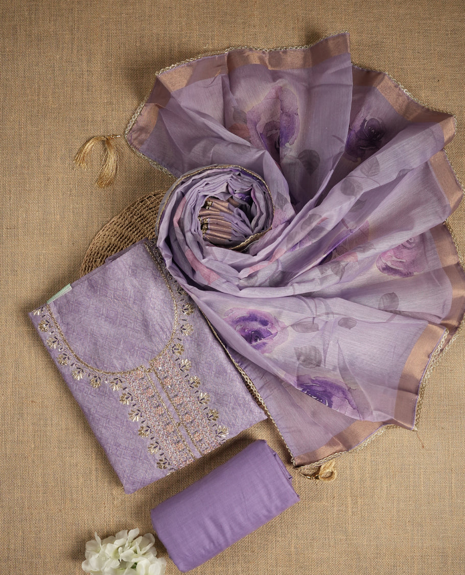 Lavender colour suit material adorned with pearls and cut beads embroidery work on the neckline, exuding a graceful charm & Paired with a floral printed dupatta and a matching plain bottom.