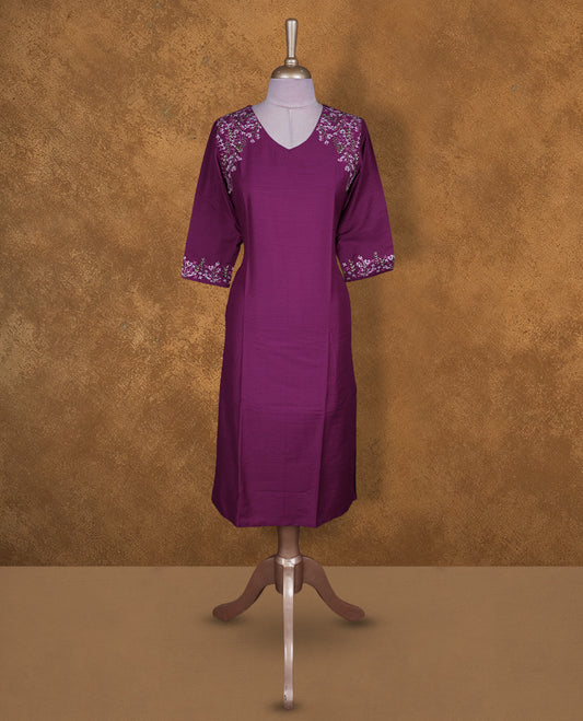 Magenta colour kurti by Talisha with V neckline, delicate floral embroidery on the shoulders and sleeve cuffs, straight calf‑length silhouette, and elbow‑length sleeves.