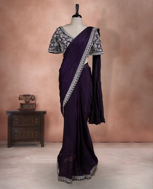 Elegant Royal purple ready to wear saree adorned with rich silver zari and bead embroidery along the border and pallu, paired with a heavily embellished matching blouse for a grand festive look.