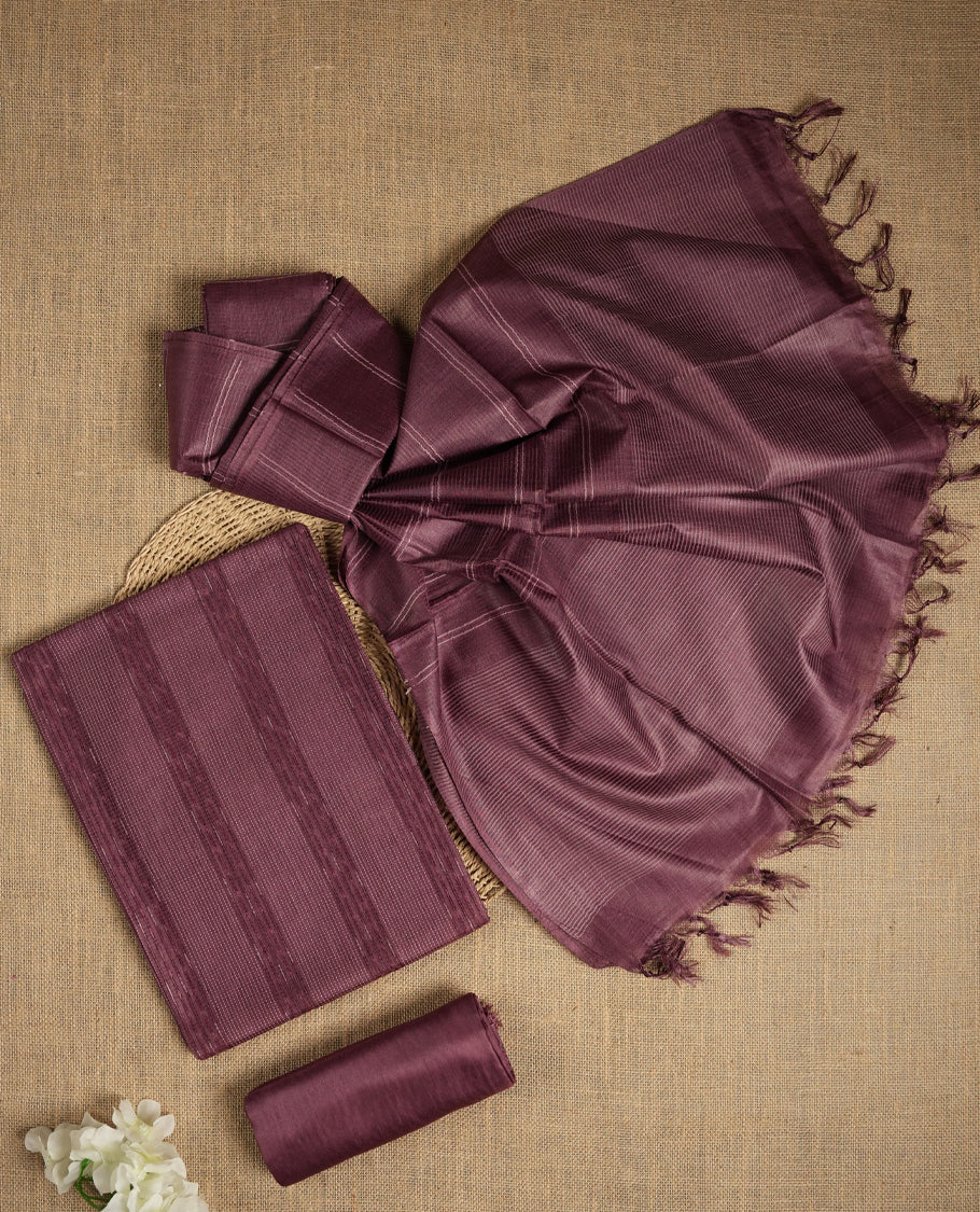 Dark mauve colour tussar suit material with elegant woven stripes & Comes with a matching dupatta adorned with tassels and a plain bottom.