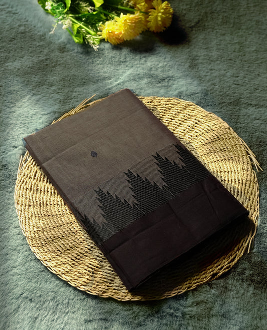 Black & Grey colour Chettinad cotton saree featuring subtle threadwork and bold black temple motifs on the border, woven in fine cotton for everyday elegance & Comes with a matching blouse piece for a traditional look.
