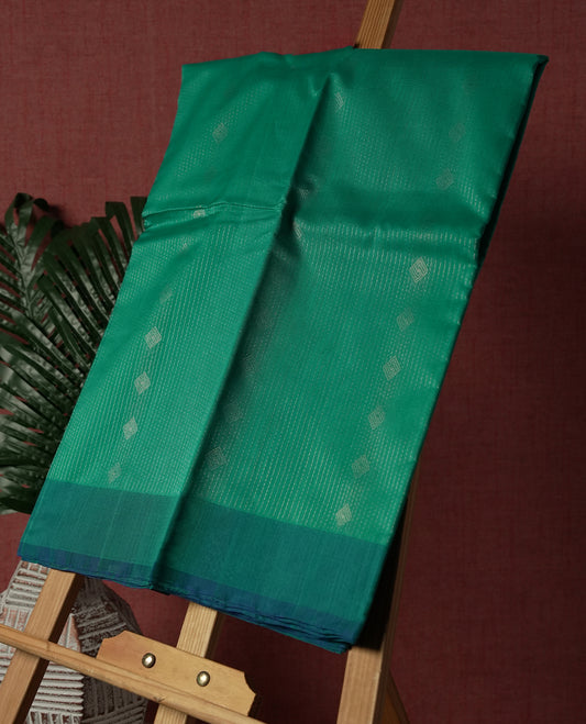 Aqua Green colour pure handloom cotton saree featuring fine golden stripes with delicate motifs, paired with a rich zari blue border for a traditional yet elegant look, perfect for graceful occasions & Comes with matching blouse.
