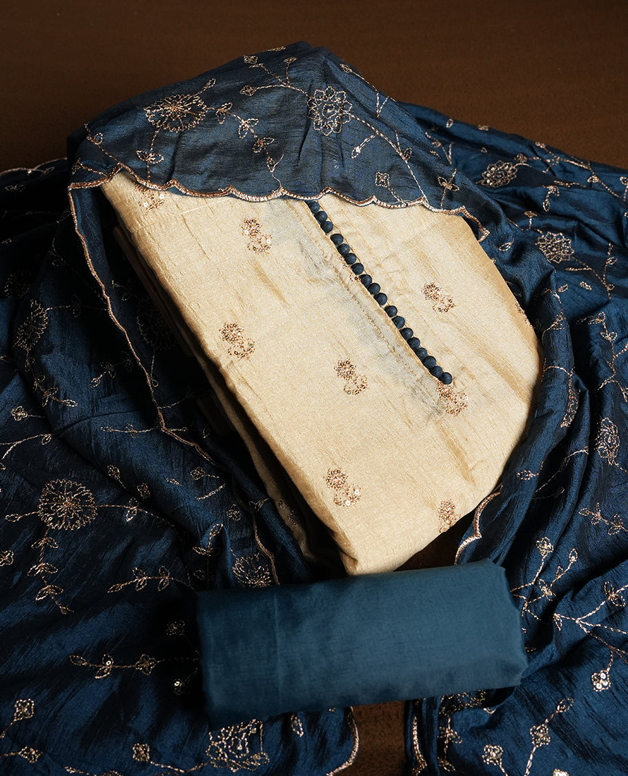 Golden Cream colour churidhar material featuring thread embroidery on the front panel, contrast Dark Teal colour dupatta with elegant border, and matching plain bottom