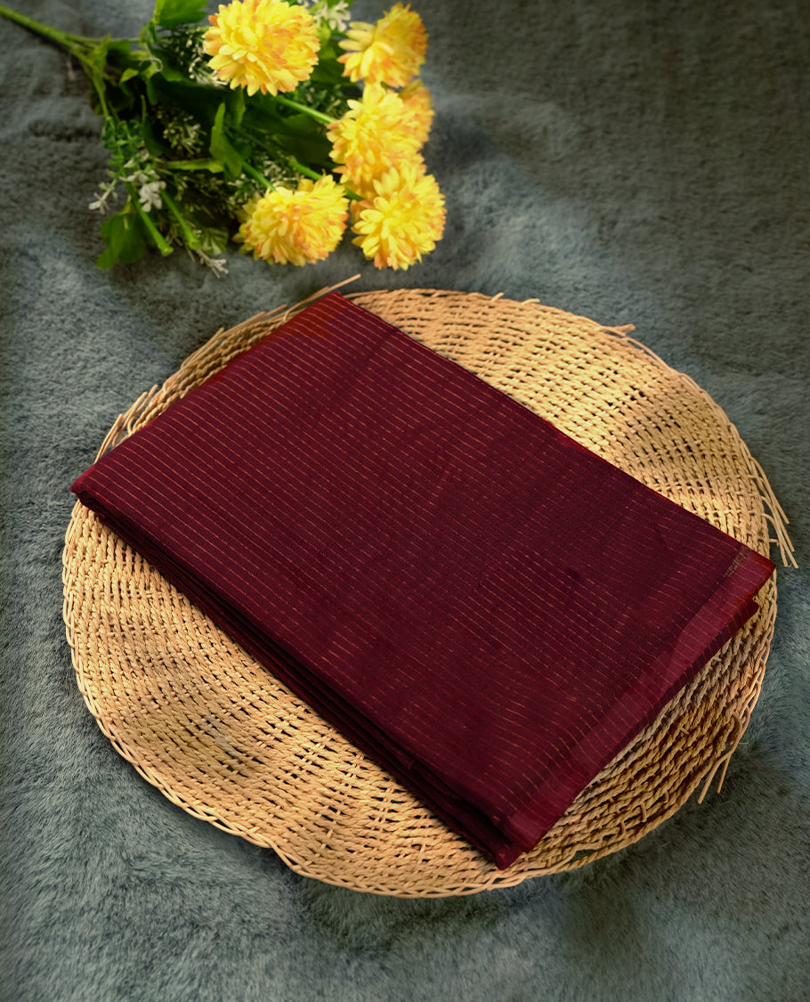Wine red colour silk cotton saree featuring with delicate vertical copper zari lines on the body, Crafted without a border for a classy touch, Mustard colour pallu & Comes with a matching blouse for a perfectly coordinated look.