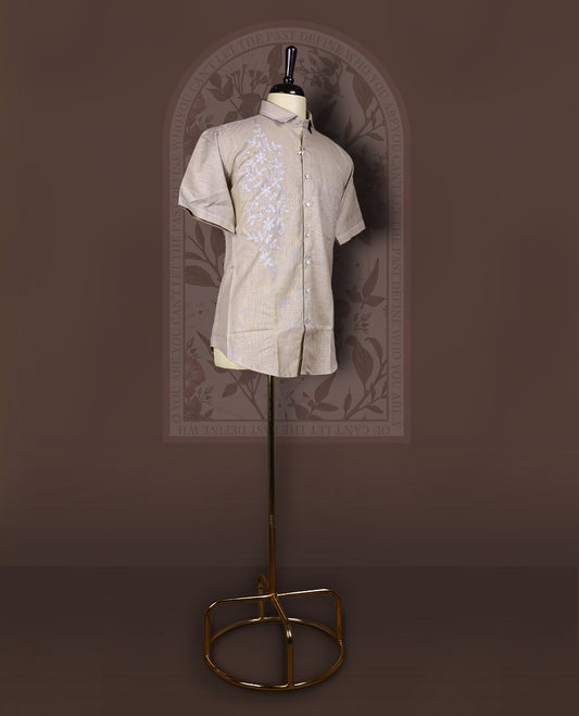 Taupe cotton linen short sleeve shirt featuring intricate white floral vine embroidery on the front, Designed with a mandarin collar and button-down style, blending artisanal detail with modern elegance.