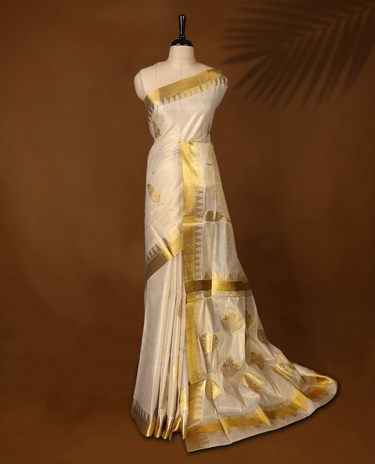 Elegant Kerala Kasavu saree in ivory with golden zari work. Perfect for festivals, weddings, and traditional events, Pair with a contrast blouse and gold jewelry for a timeless, graceful look.