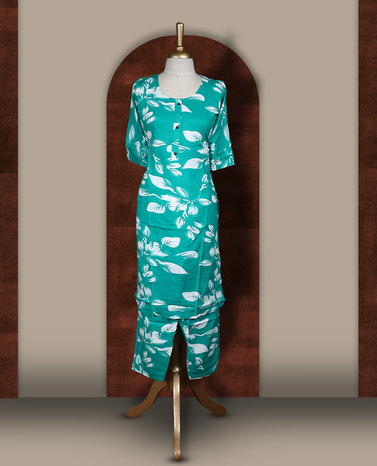 Green colour coord set adorned with bold white floral prints on the body, featuring a straight cut kurta with round neckline and half sleeves, paired with matching bottoms.