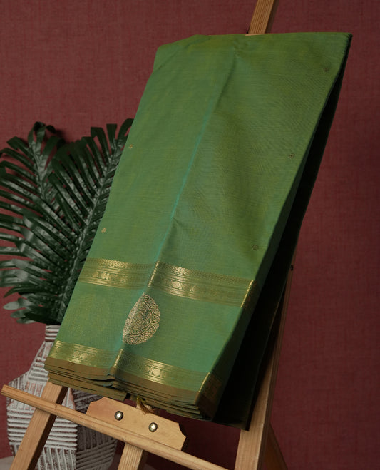 Fern Green colour Pure Kanchi cotton saree featuring delicate golden buttas and a rich zari border with intricate motifs & Paired with a matching blouse, it exudes timeless elegance, perfect for festive and traditional occasions.
