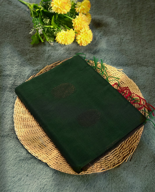Dark greeen colour soft silk cotton saree adorned with copper zari motifs and a shimmering copper zari border, Enhanced by a beautifully rich maroon colour woven pallu & Comes with a matching blouse piece for a complete look.