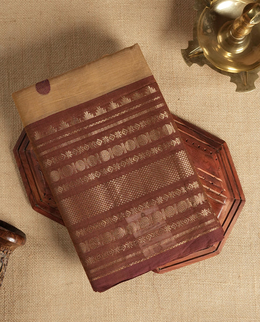Pastel brown colour Chettinad cotton saree featuring intricate dark contrast golden zari weaving on the border , The rich traditional motifs add a regal charm & Comes with a matching blouse piece.