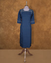 Deep blue colour kurti by Talisha with round neckline, delicate white floral embroidery on the neck and sleeves, straight calf‑length silhouette, and three‑quarter sleeves with contrast stripe cuffs.