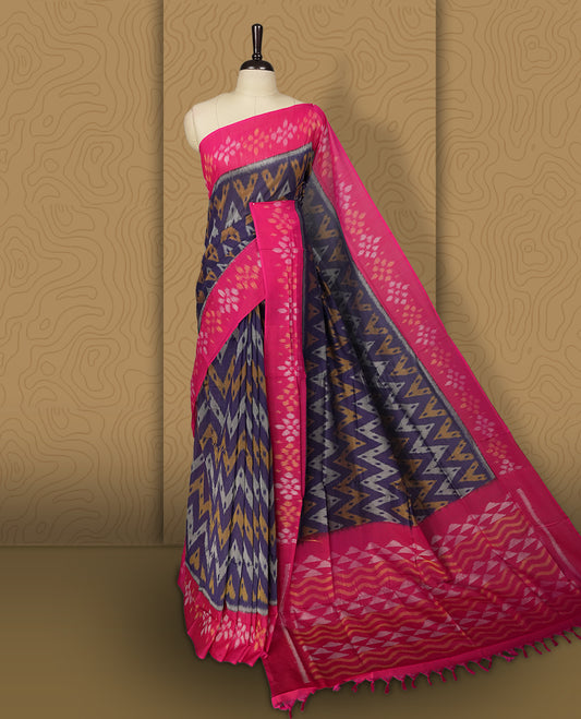 Navy blue colour Ikkat Pochampally saree featuring a vibrant magenta pink border and pallu adorned with traditional ikat motifs in shades of beige & grey, bringing a perfect blend of heritage and modern charm, Comes with matching blouse.