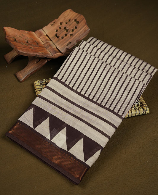 Off white and brown colour mixed chanderi cotton saree with vertical striped body, brown and off-white triangle geometric border, golden zari border, and matching brown blouse.