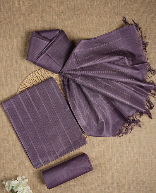 Lavender colour tussar suit material adorned with intricate woven patterns and subtle motifs, exuding ethnic elegance & Paired with a beautifully bordered dupatta and a matching plain bottom.
