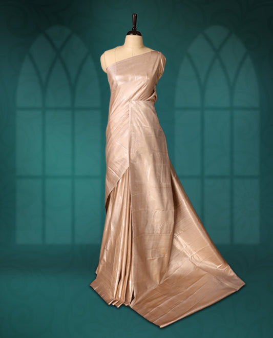 Beige colour semi silk saree featuring a plain lustrous body, complemented by a rich self colour woven border and pallu, paired with a matching blouse.