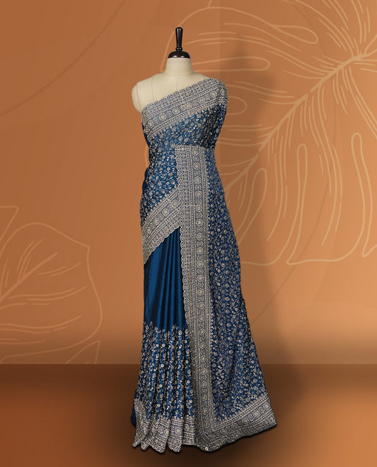 Royal blue colour velvet chiffon designer saree in elegant two tone shades, featuring light gold zari, kodi work with handwoven style thread aari & dori embroidery work, Swarovski stone work and all over motifs, comes with matching blouse.