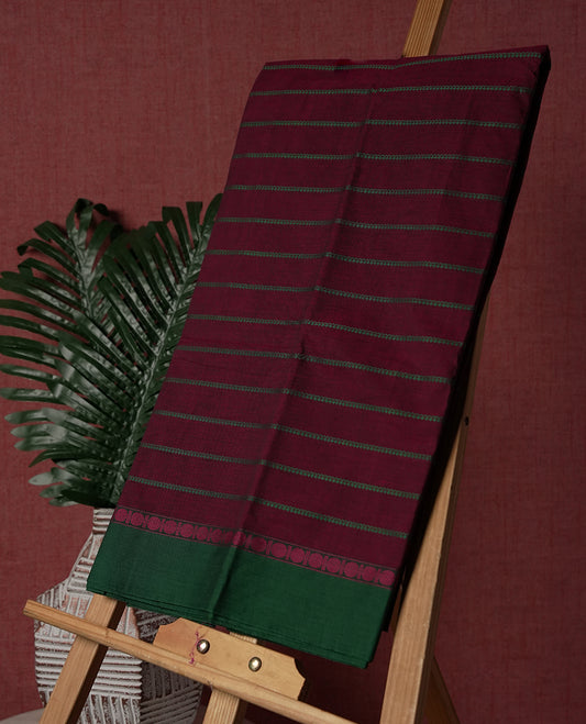 Maroon colour Pure Kanchi cotton saree with subtle green stripes and a contrasting green border & Includes a matching blouse piece for a complete look.