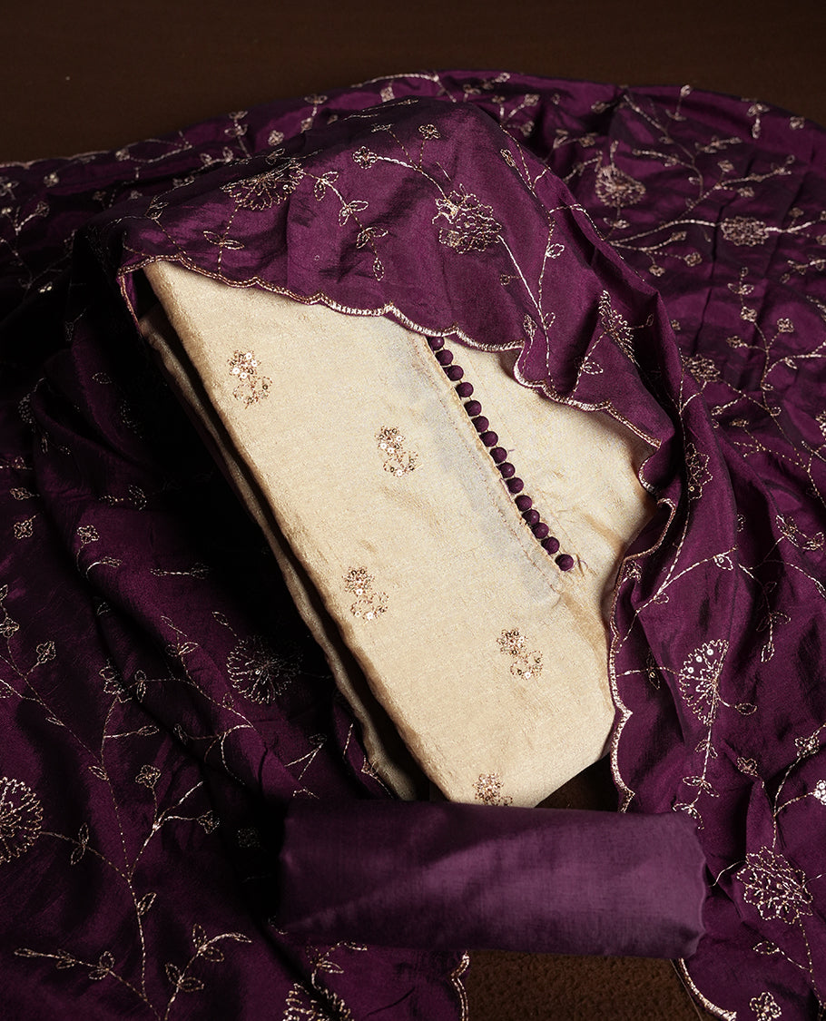Golden Cream colour churidhar material featuring thread embroidery on the front panel, contrast Dark Purple colour dupatta with elegant border, and matching plain bottom