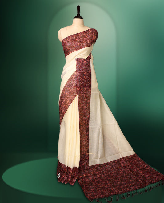 Off White colour kota net saree adorned with Plain body, enhanced by a deep maroon Printed border for bold contrast, and paired with a matching blouse