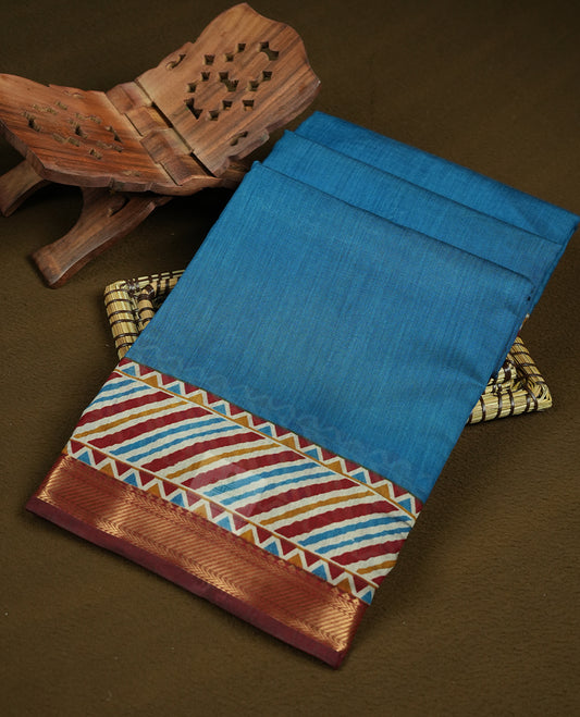 Teal blue colour mixed chanderi cotton saree with plain body, multicolor striped and geometric pallu with triangle patterns, maroon and golden zari border, and matching maroon blouse.